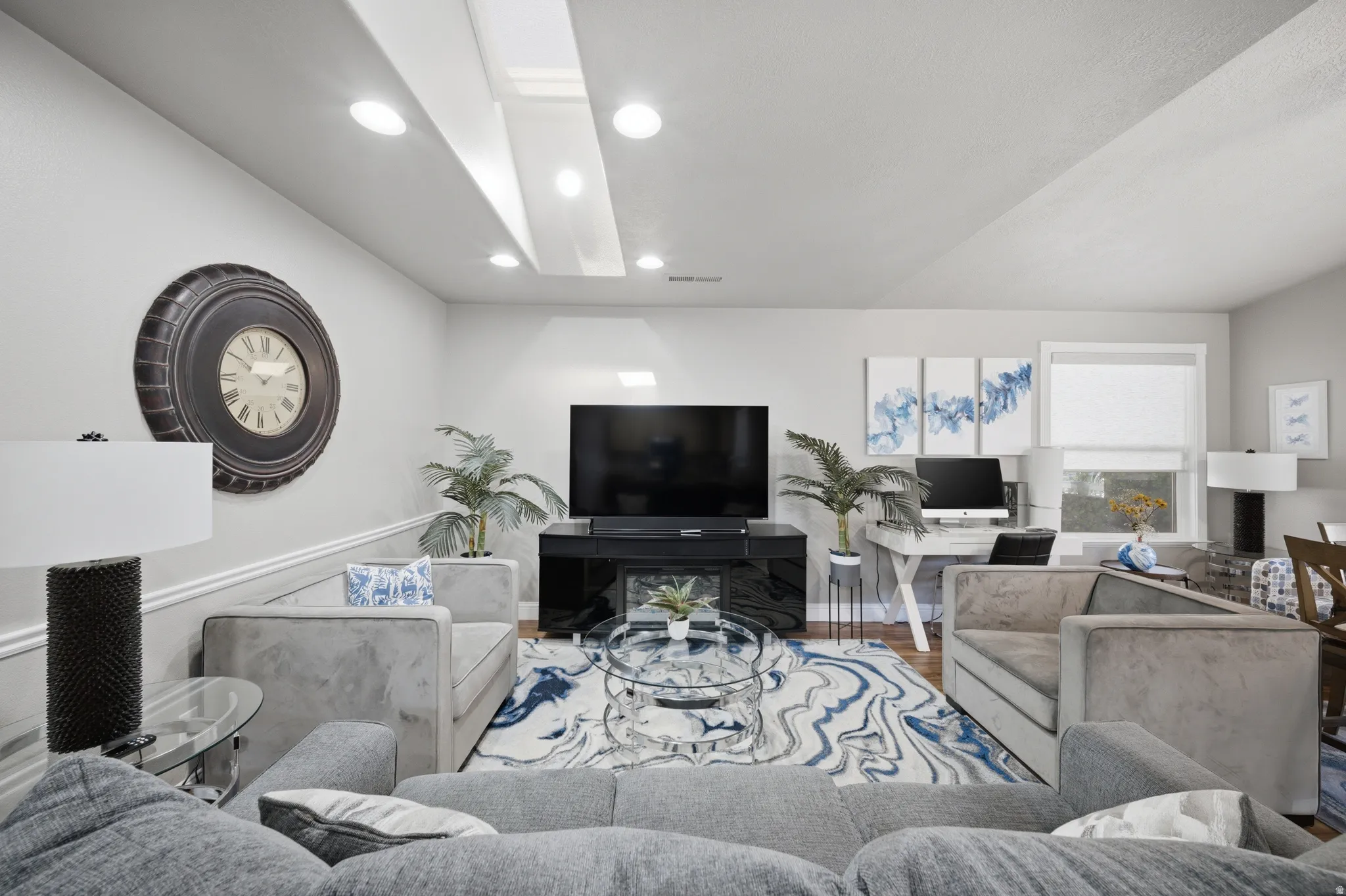 Living area featuring wood finished floors and recessed lighting