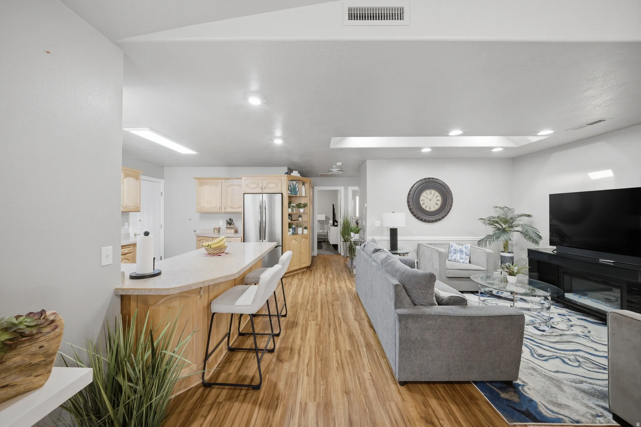 Living area featuring light wood-style flooring and recessed lighting
