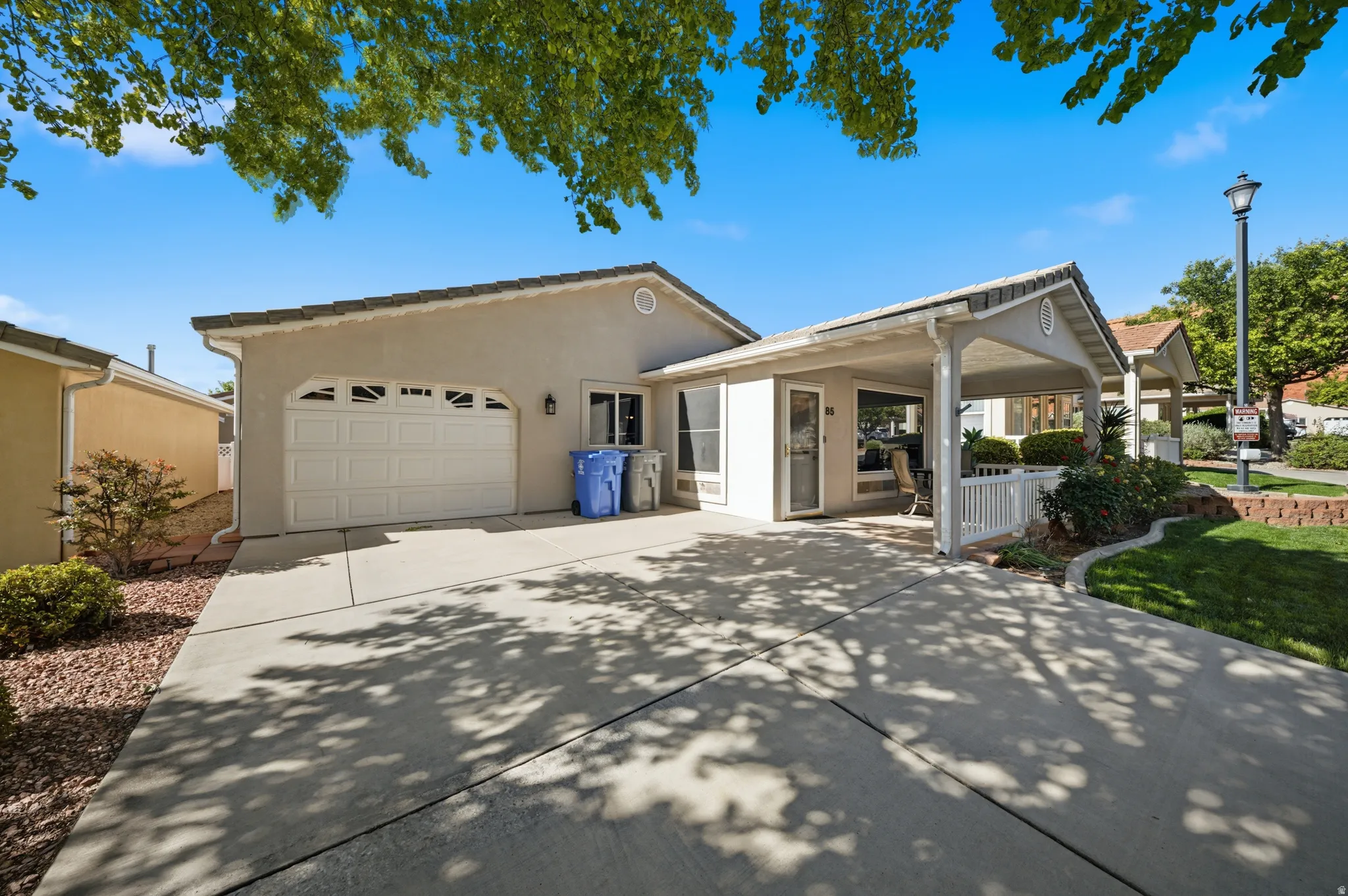 Single story home featuring an attached garage, driveway, and stucco siding