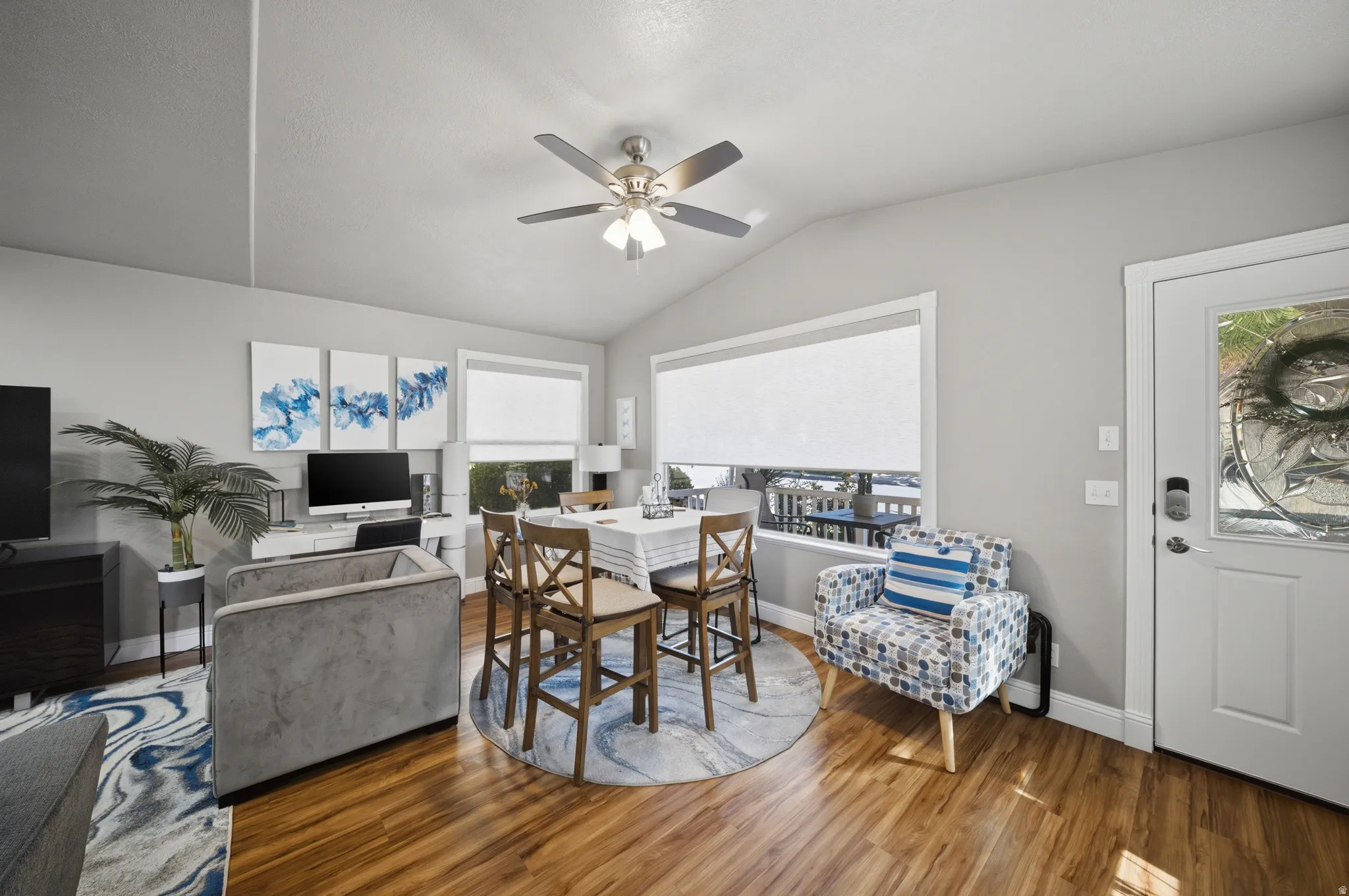 Dining room with lofted ceiling, a ceiling fan, and wood finished floors