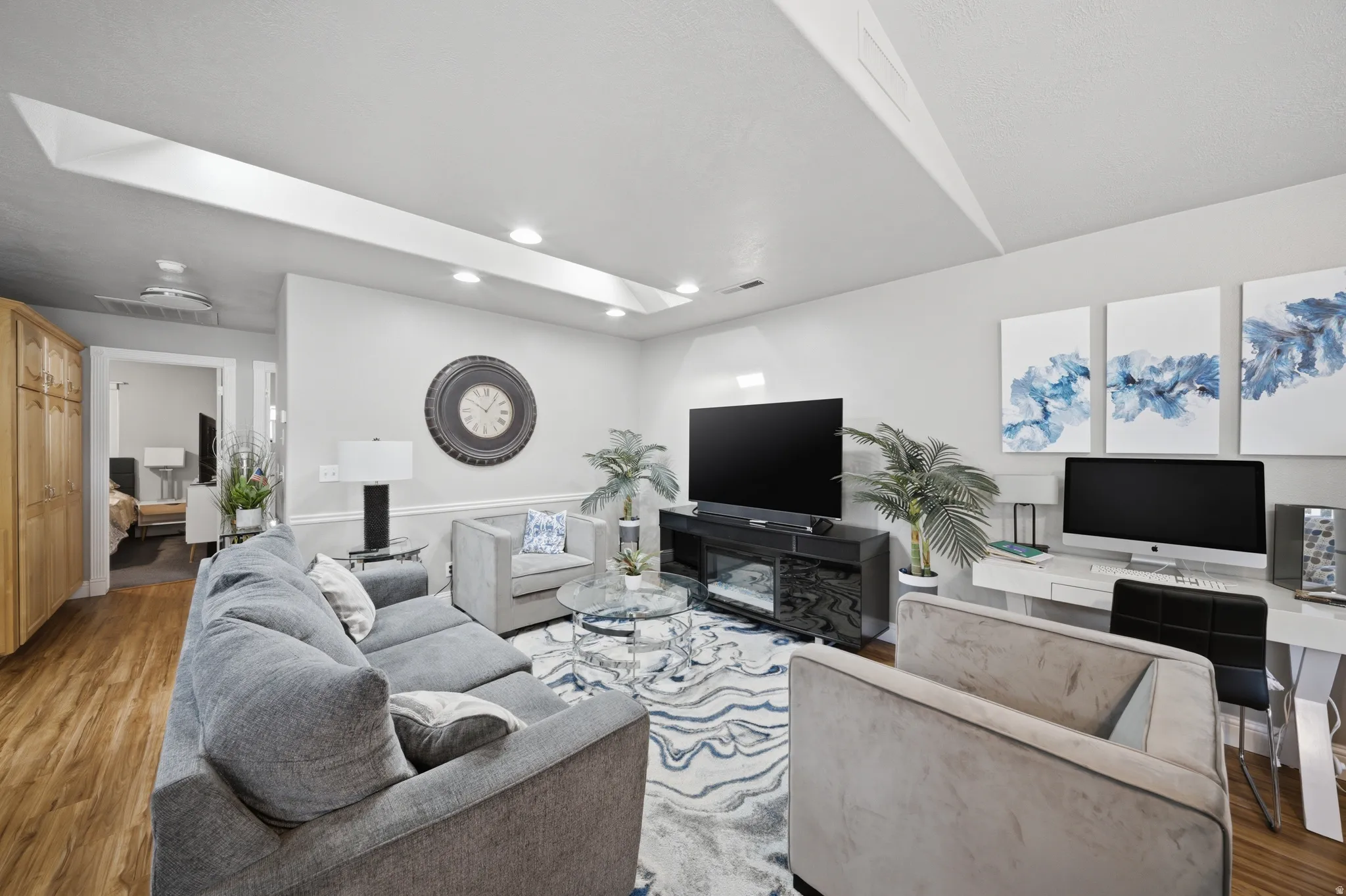 Living area with wood finished floors and recessed lighting