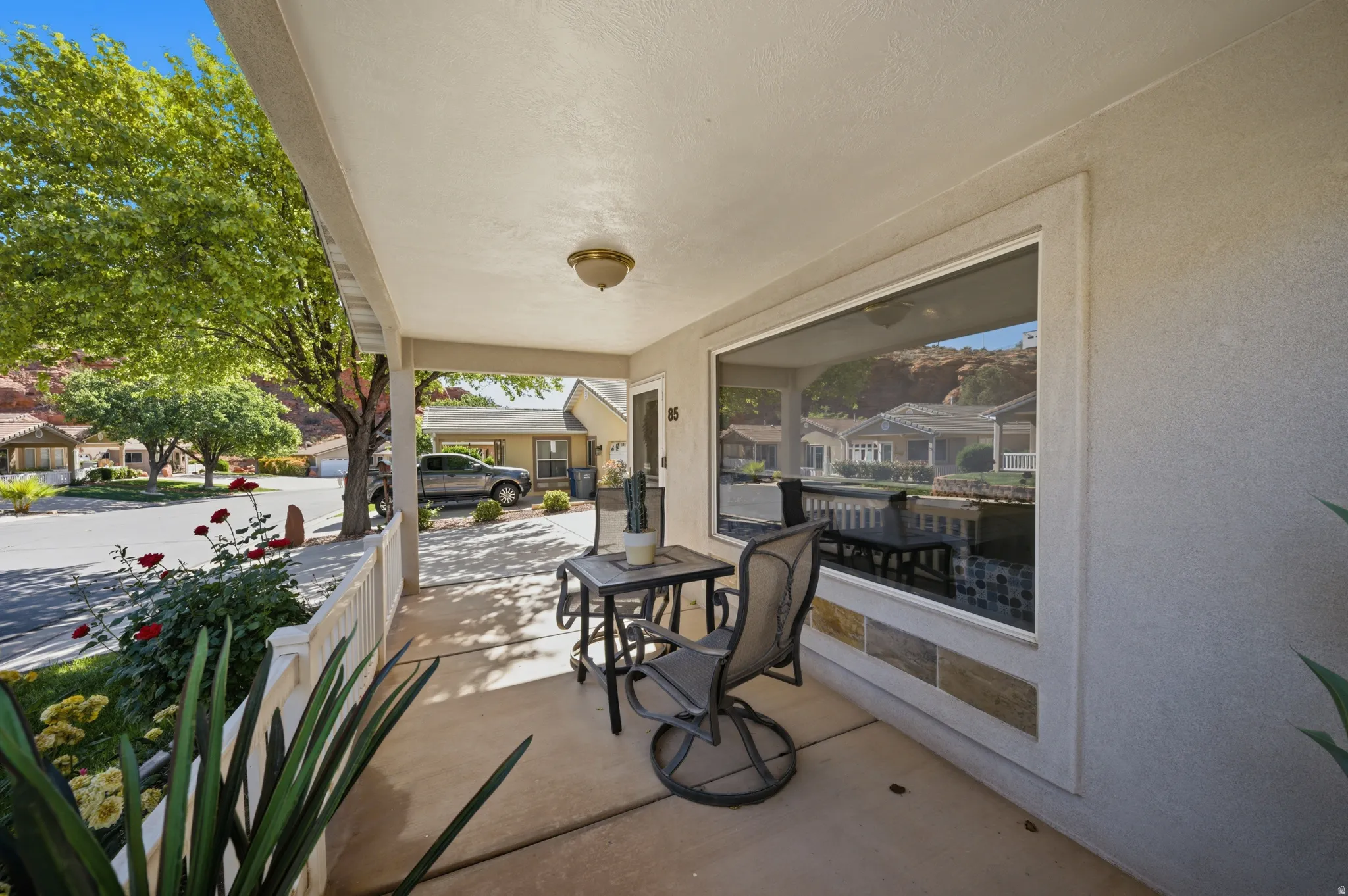 Covered porch featuring a residential view