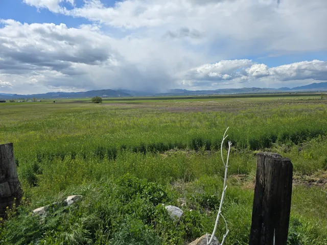 View of mountain backdrop with rural landscape