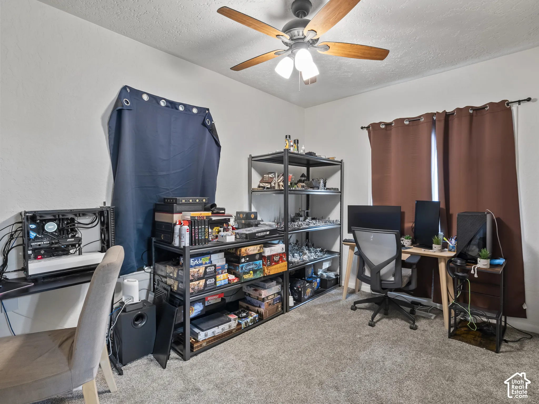 Home office with light carpet, a textured ceiling, and a ceiling fan