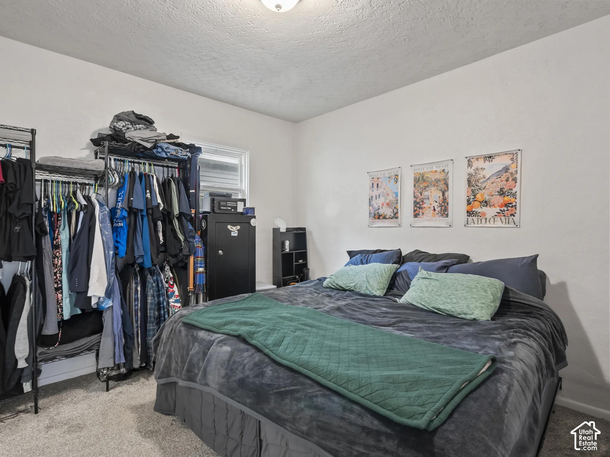Bedroom with carpet floors and a textured ceiling