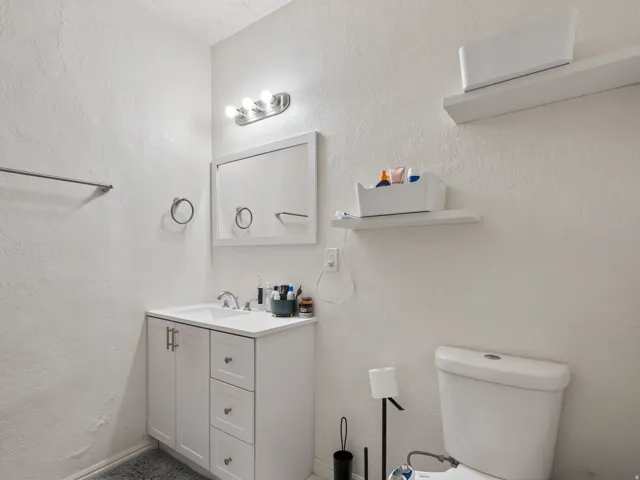 Bathroom featuring vanity and a textured wall