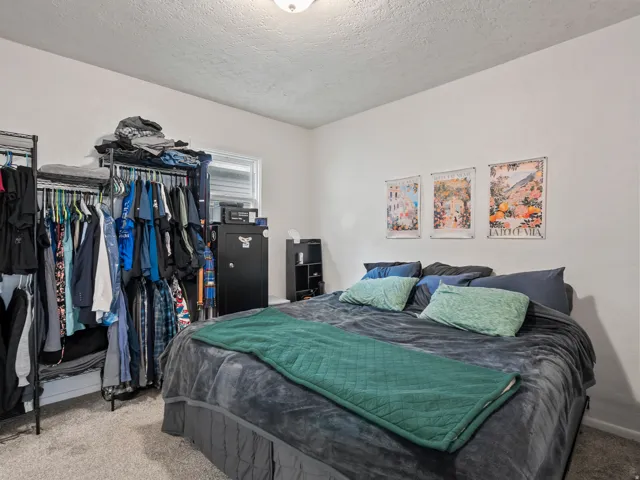 Bedroom with carpet floors and a textured ceiling