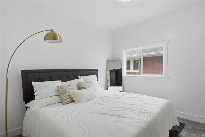 Bedroom featuring baseboards and carpet floors