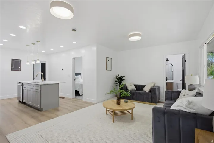 Living room featuring light wood-style flooring and recessed lighting