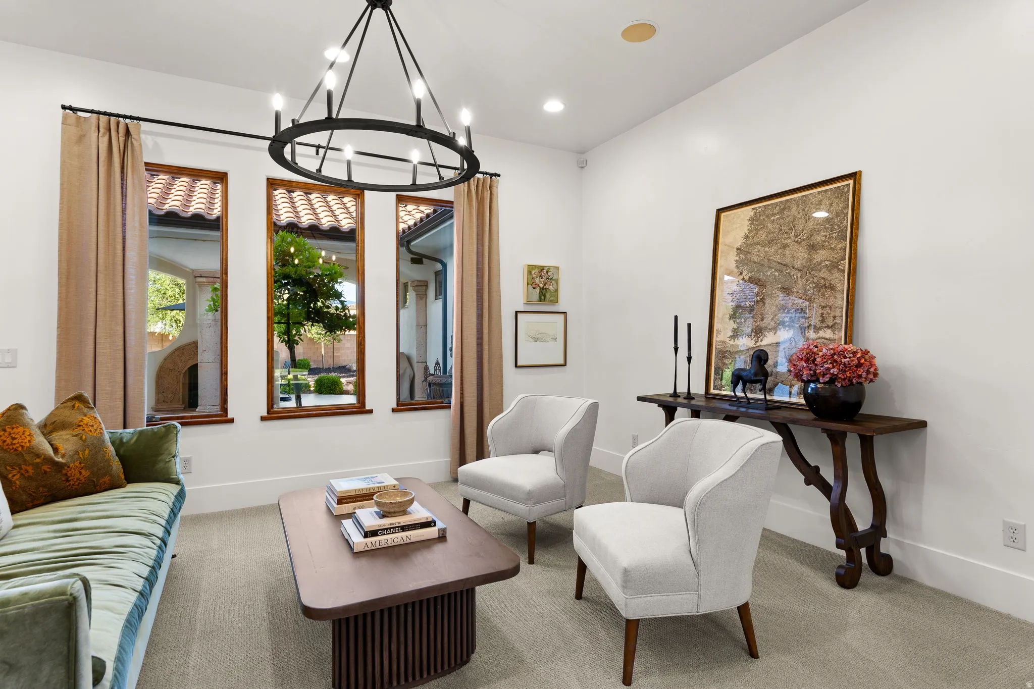 Living area featuring hanging lights and carpet