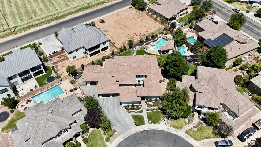 Aerial perspective showcasing a cul-de-sac property with mature landscaping and a long, curving driveway