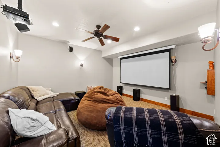Home theater room with a ceiling fan and recessed lighting