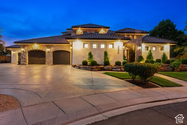 Stucco exterior with stone accents and a terracotta tile roof