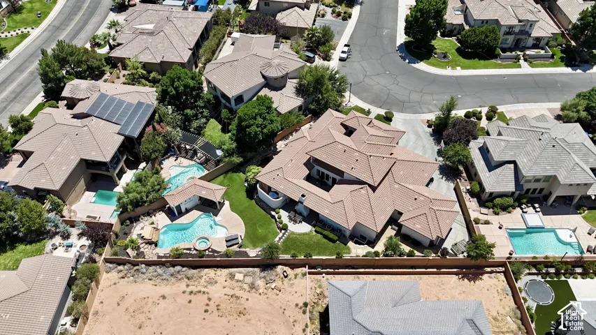 Expansive property featuring a multi-level tile roof, multiple swimming pools, a spa, and mature landscaping