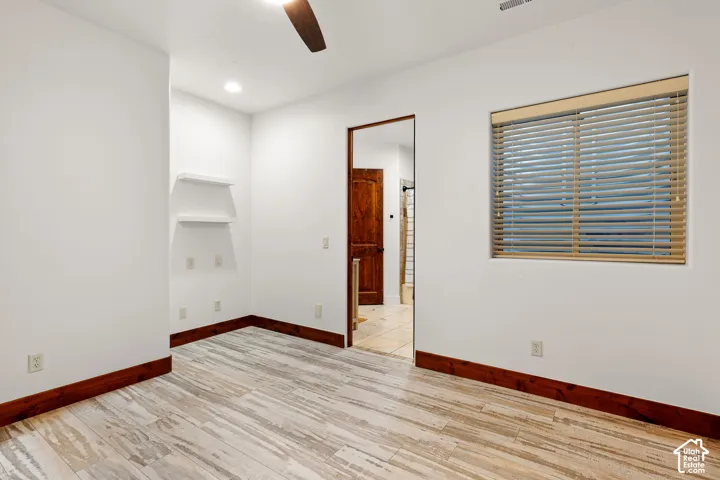 Empty room with light wood-style flooring, a ceiling fan, and recessed lighting