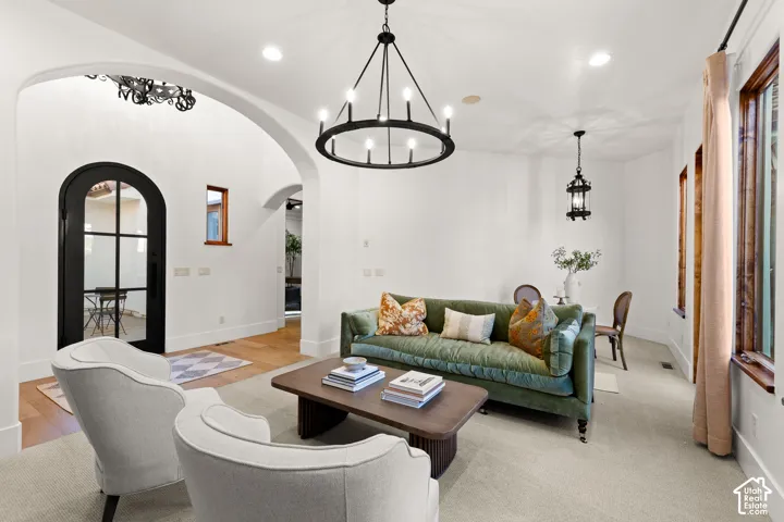 Living room with a chandelier and arched walkways