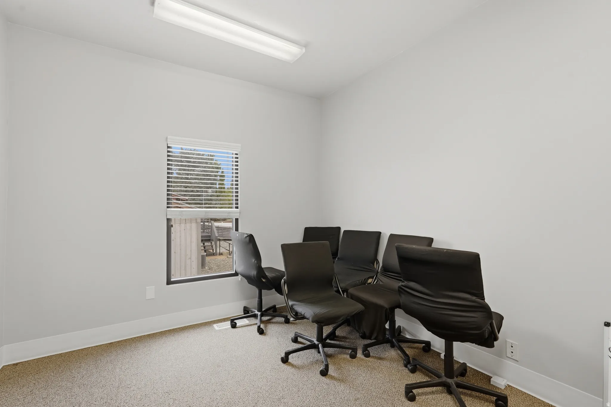 Home office with light colored carpet