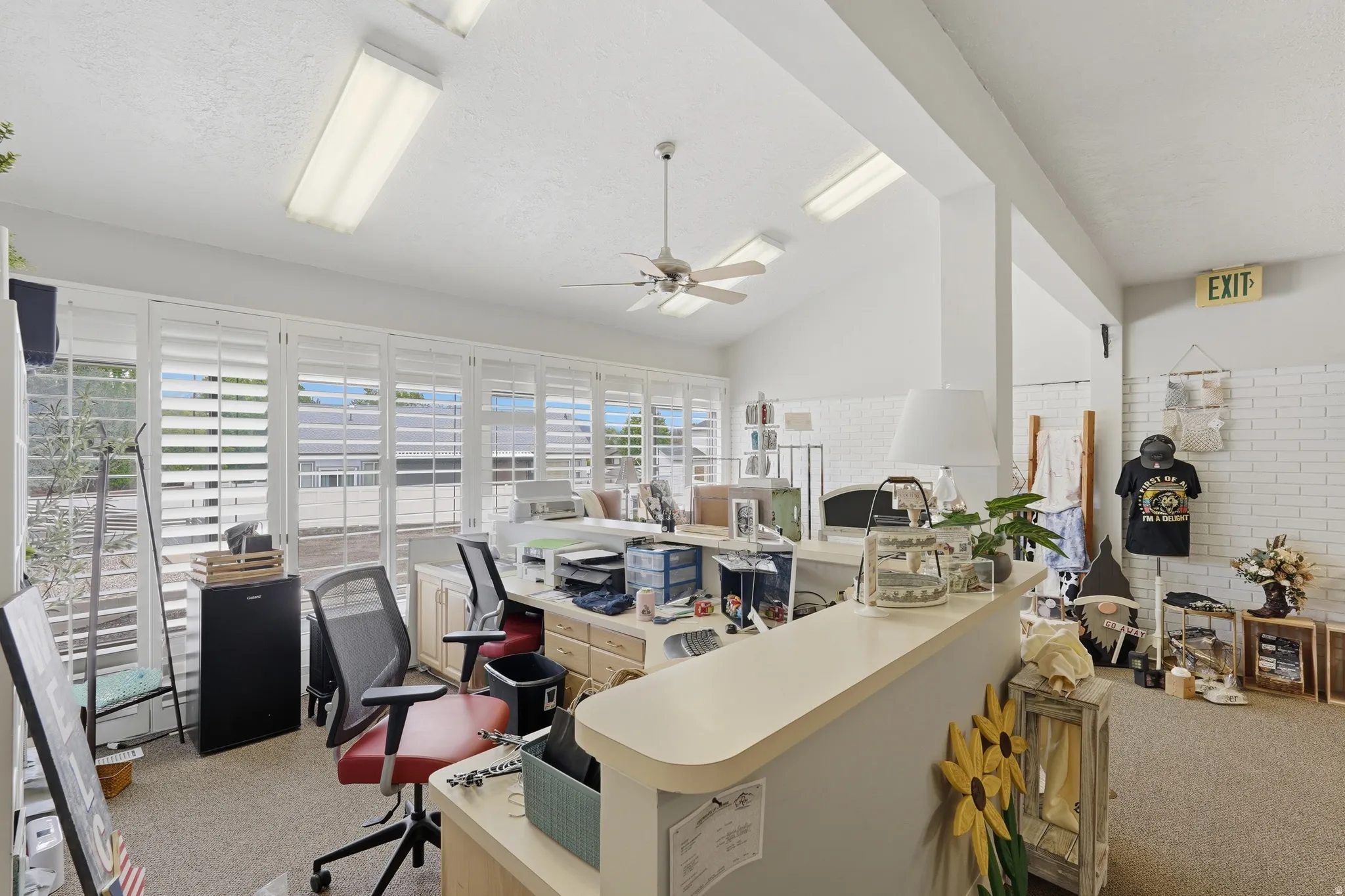 Office with vaulted ceiling and ceiling fan