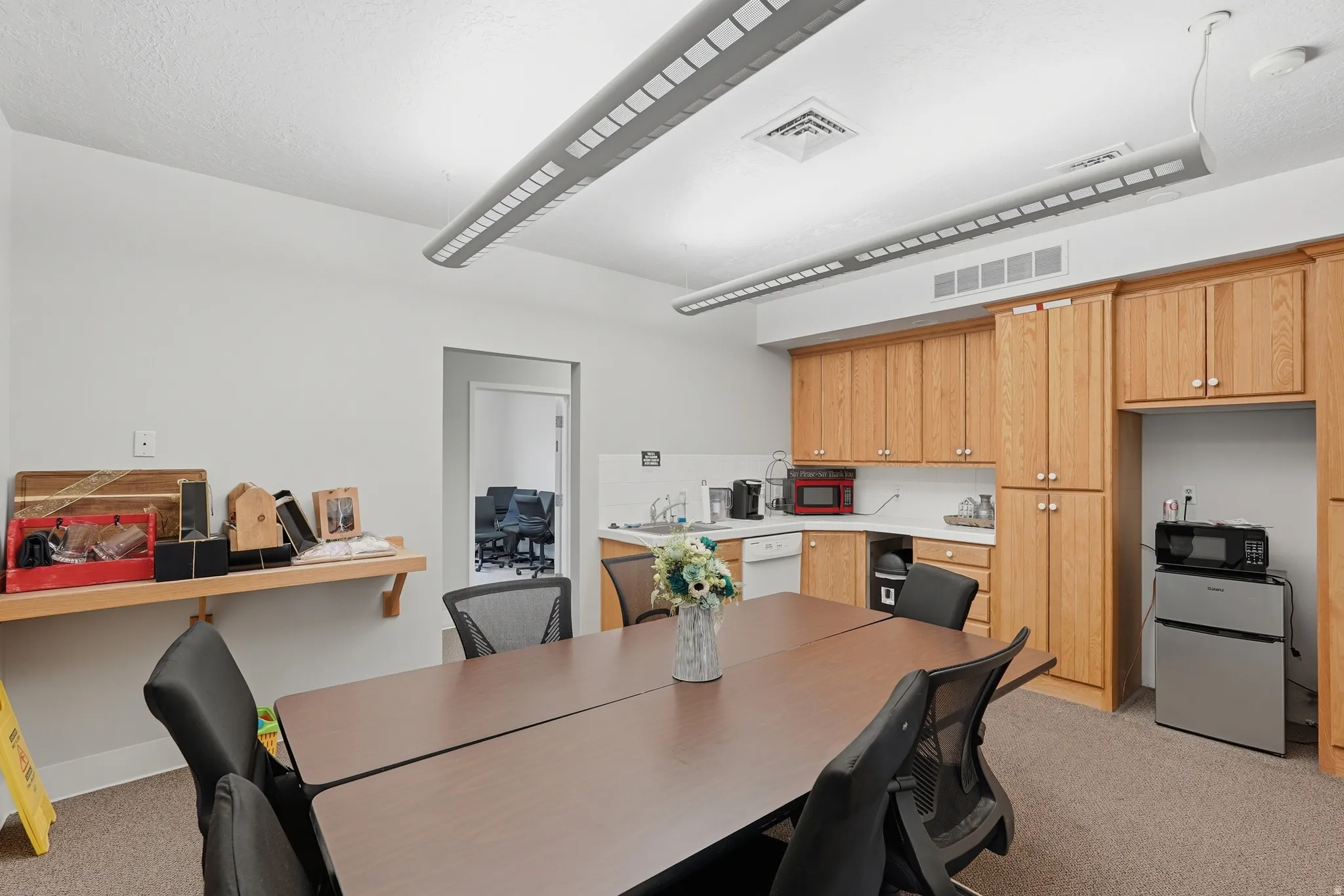 Dining room with light carpet and a desk