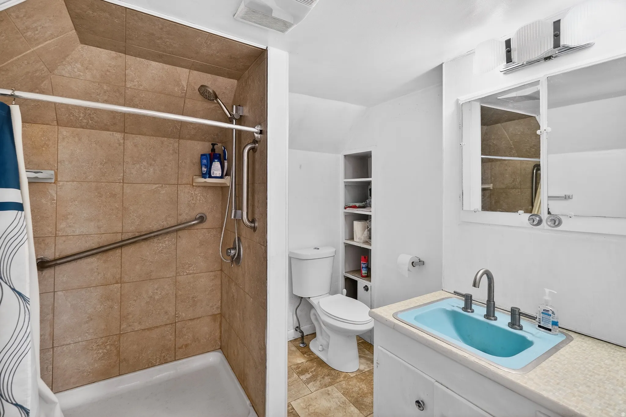 Bathroom with vanity and a stall shower