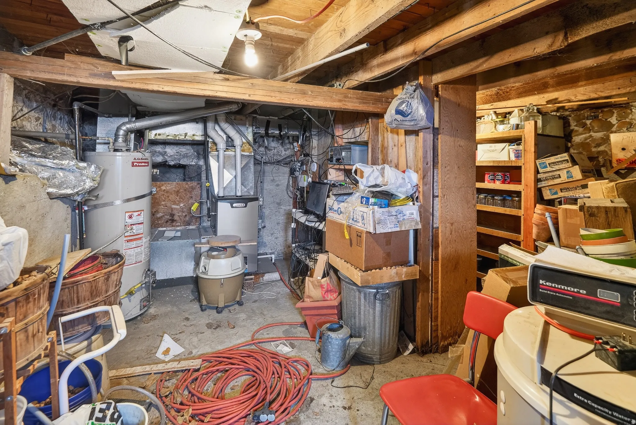 Unfinished basement with water heater and heating unit