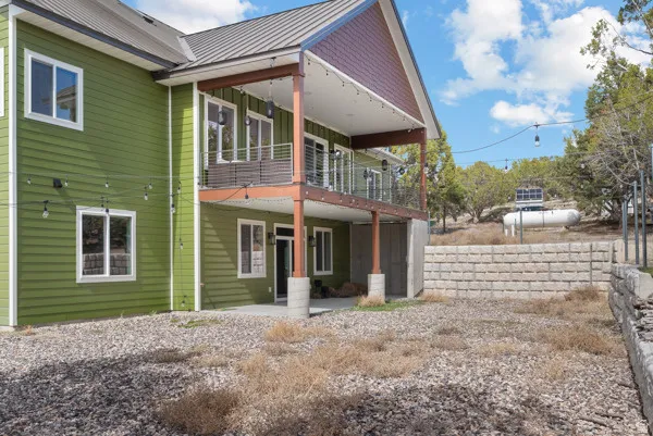Rear view of house with a metal roof and a patio area