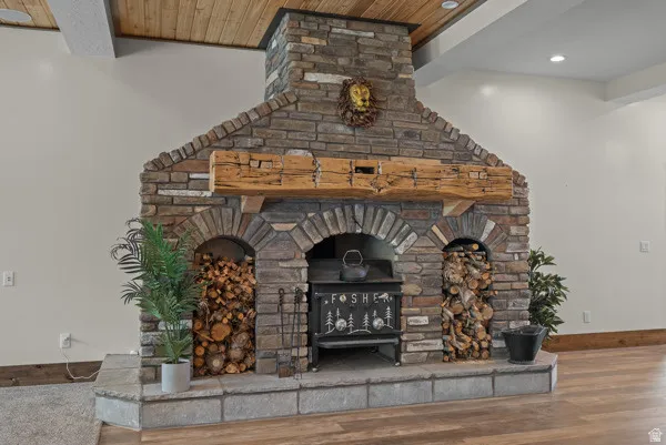 Detailed view of a large fireplace and wood finished floors