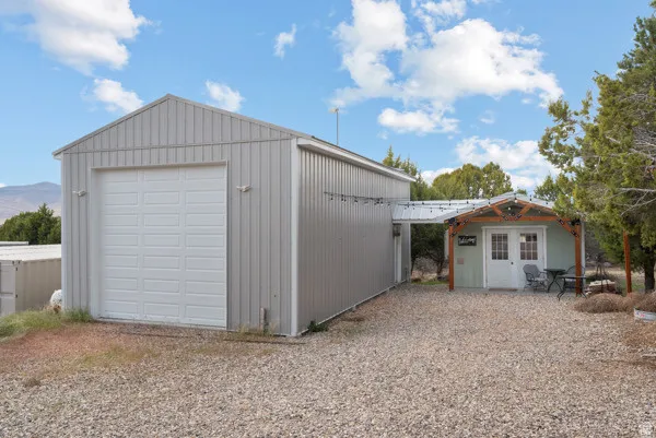 Detached garage with gravel driveway