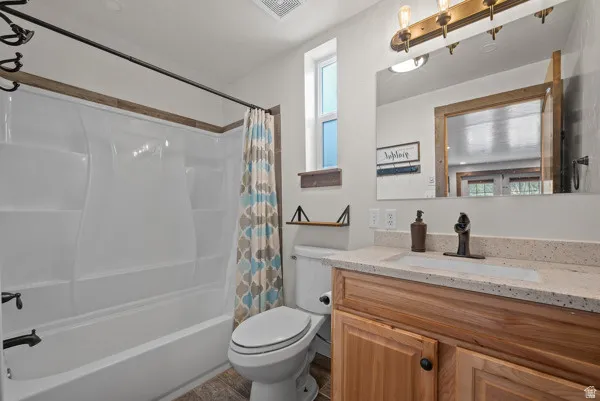 Full bath with vanity and shower / bath combo with shower curtain