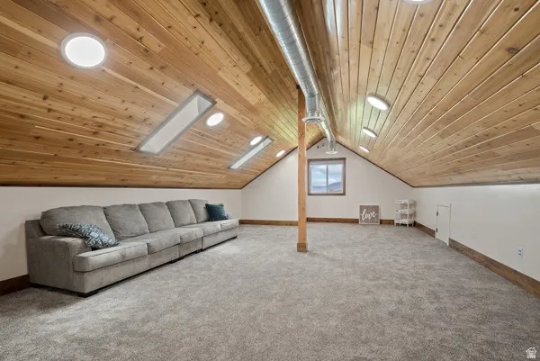 Bonus room featuring wooden ceiling, carpet floors, and a skylight