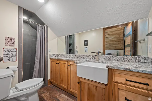 Full bath with vanity and a shower with shower curtain