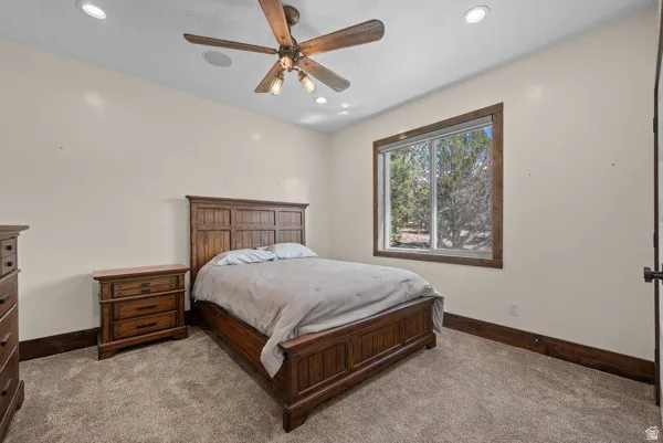 Bedroom with carpet, a ceiling fan, and recessed lighting