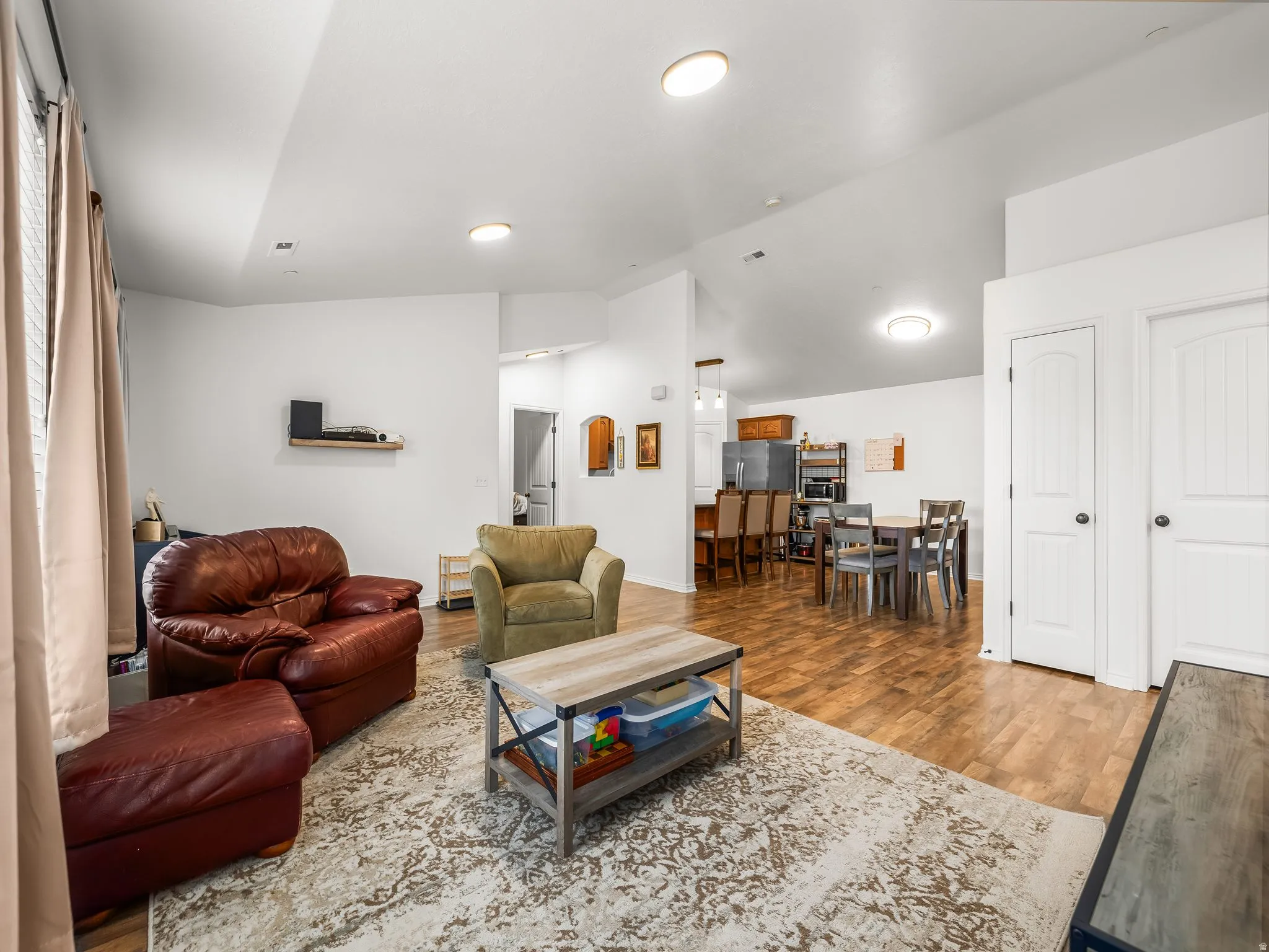 Living room with vaulted ceiling and wood finished floors