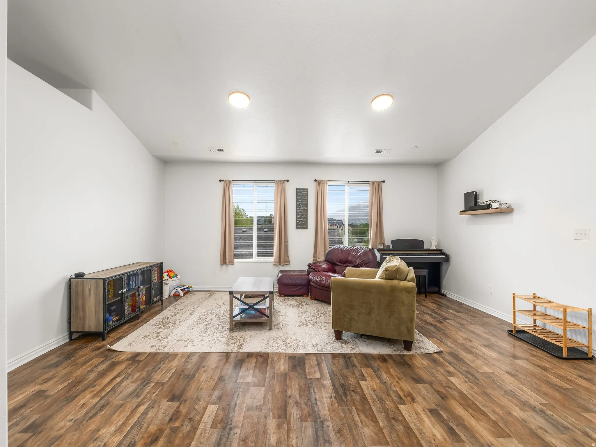 Living area with dark wood-style floors and baseboards