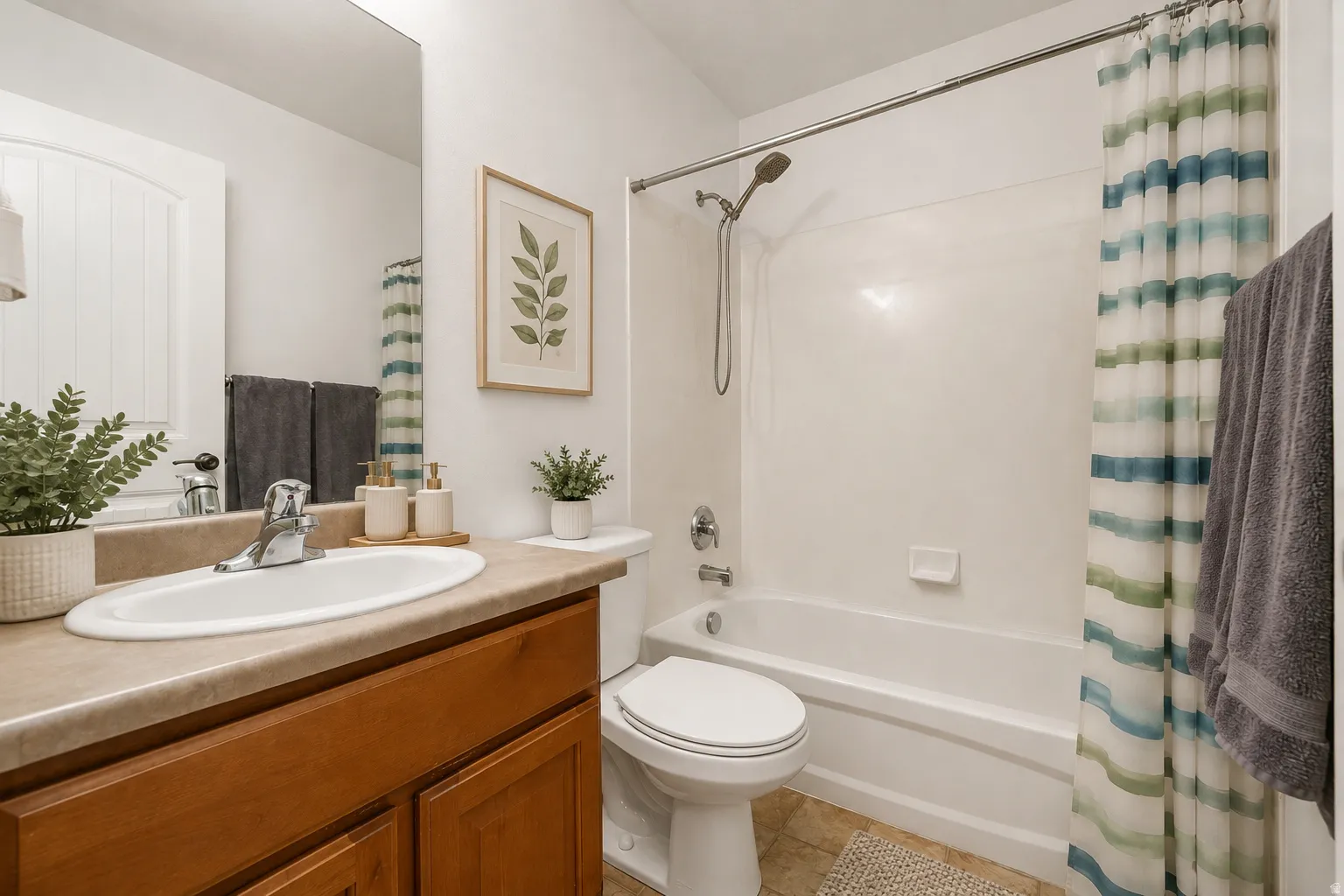 Spa-inspired bathroom featuring a wood-finish vanity with an undermount sink, generous countertop space, and chrome fixtures