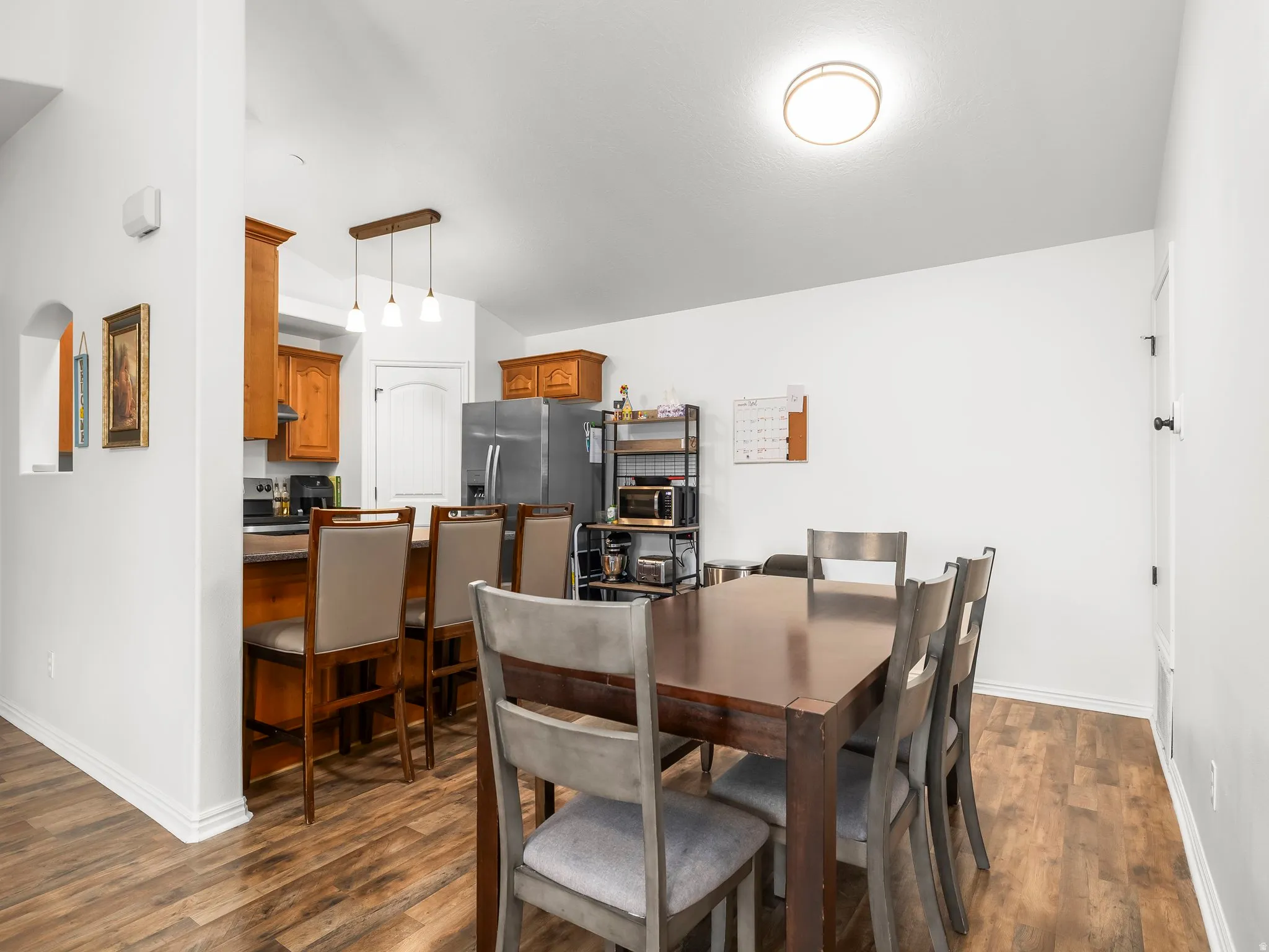 Wood-finish flooring throughout, with a recessed archway detail