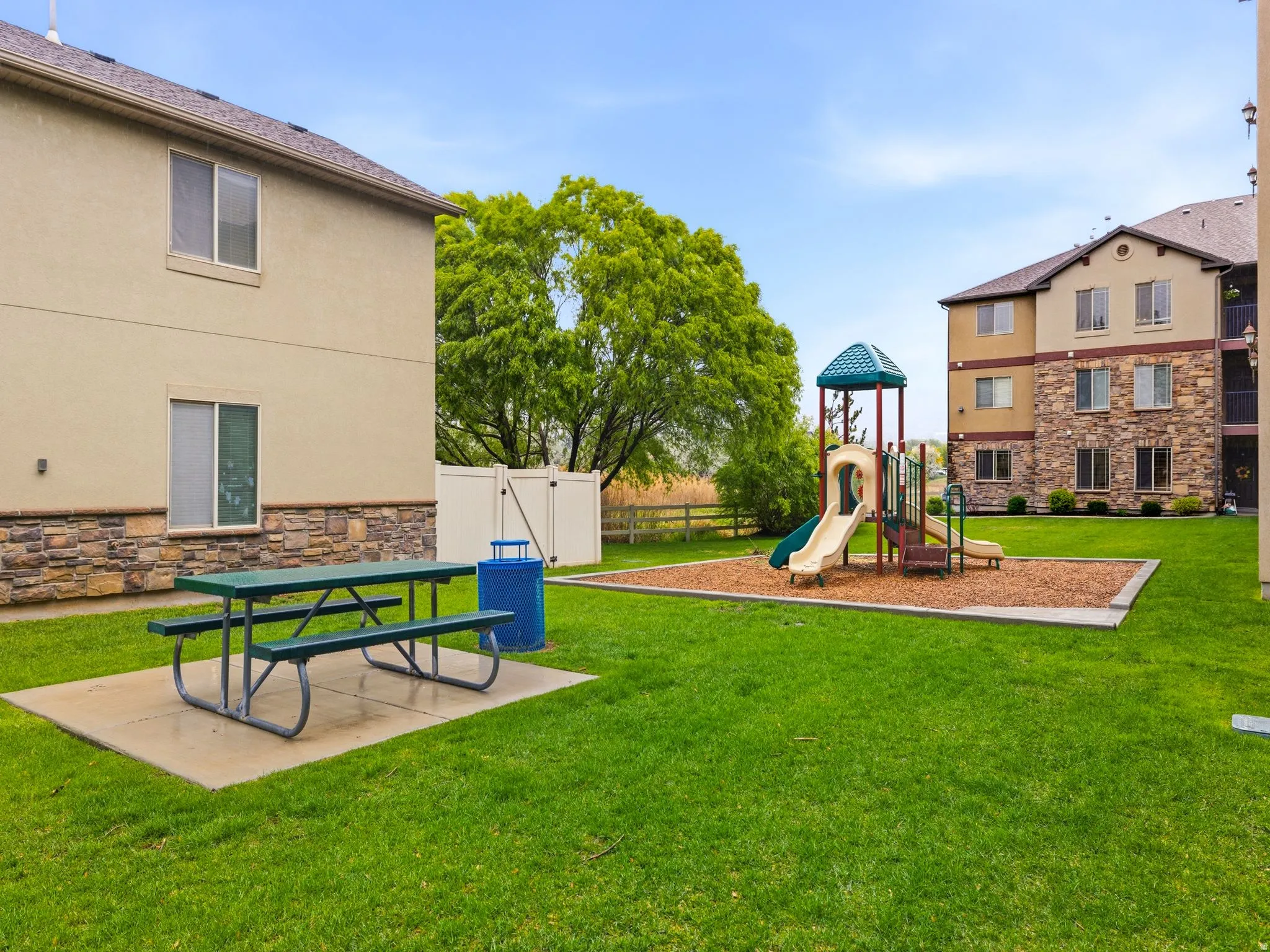 Community open space featuring picnic area and small tot lot.