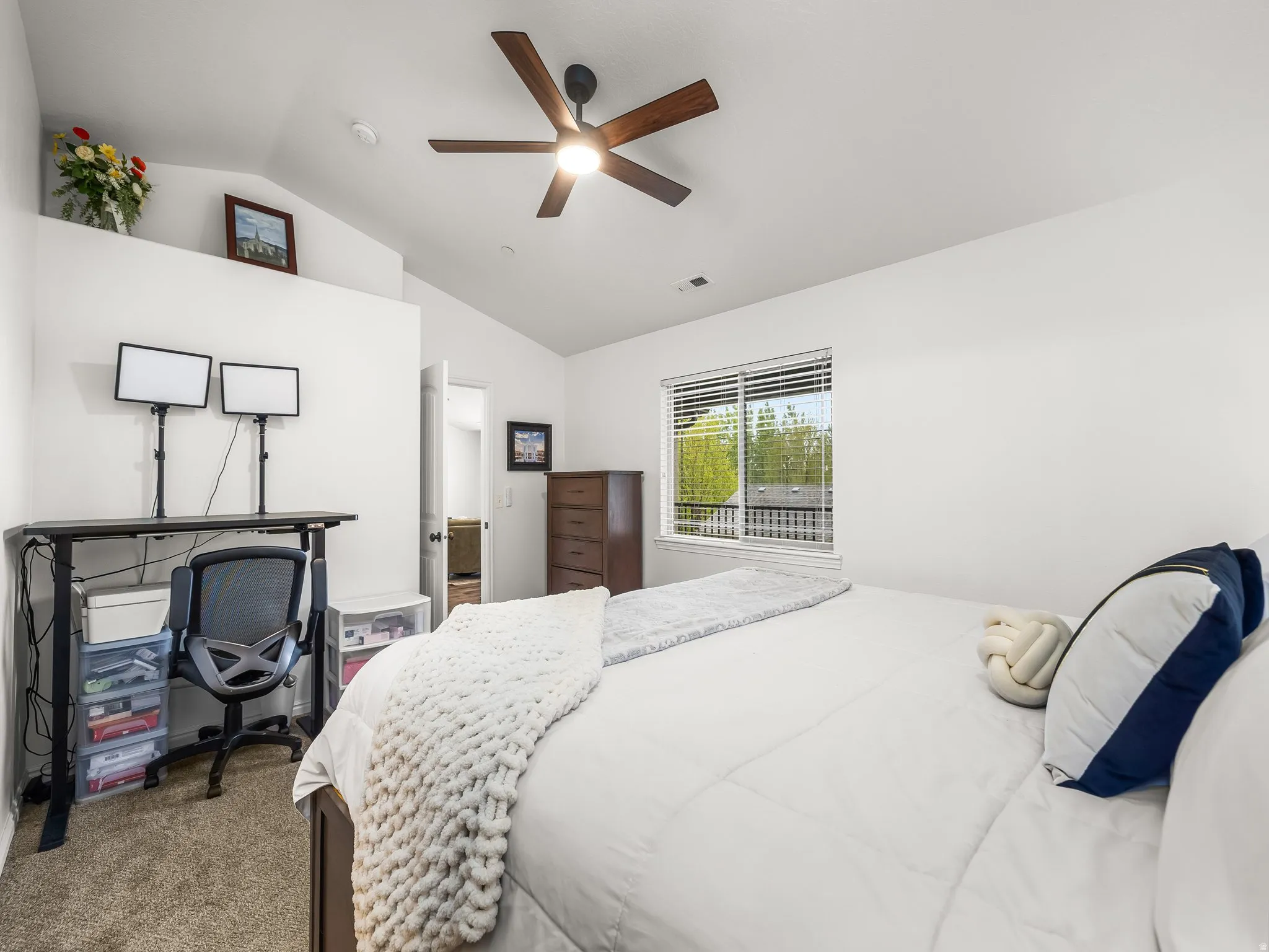 Vaulted ceiling, ceiling fan, carpet flooring, window with blinds, and white walls