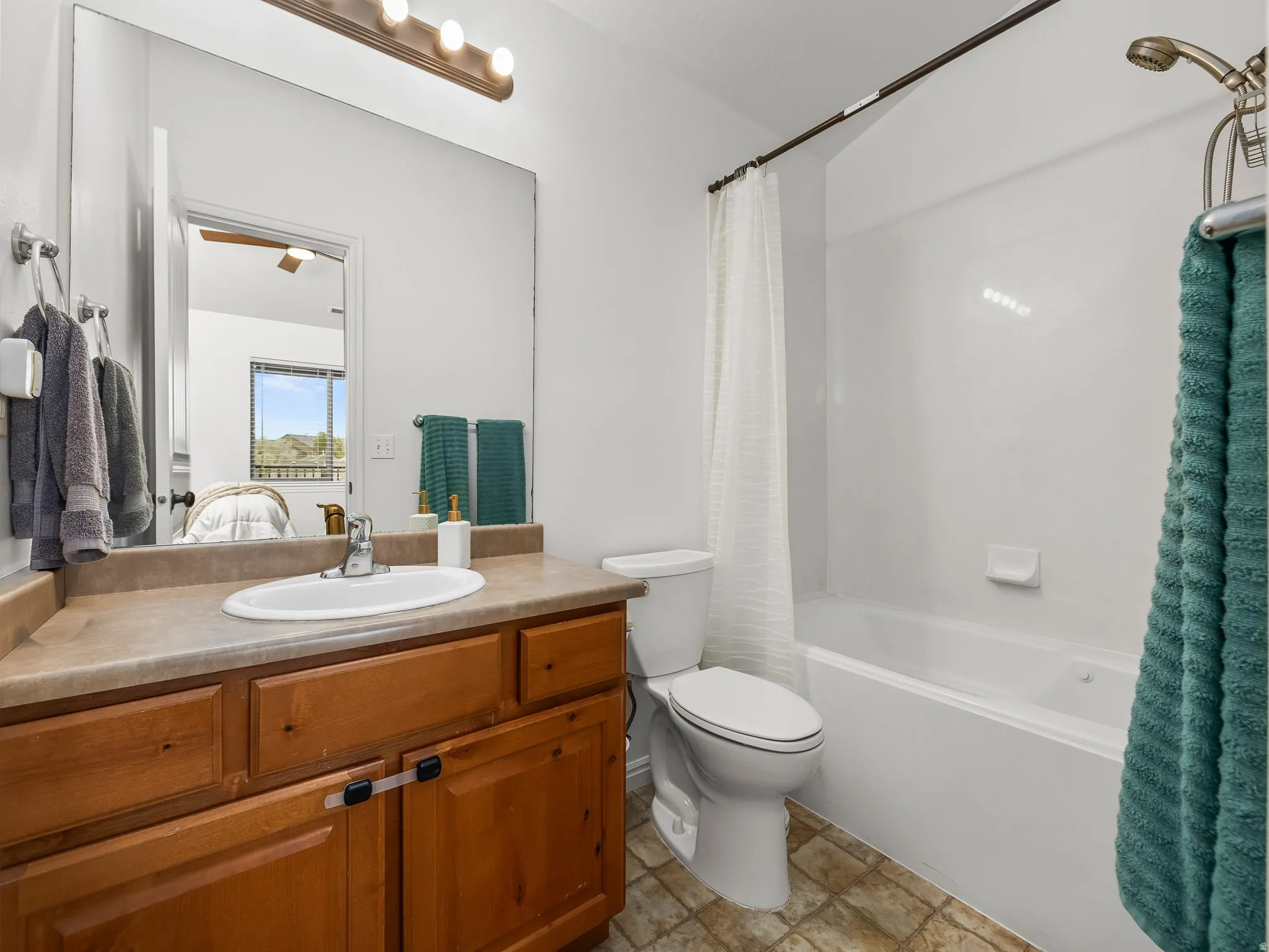 Wood-finish vanity with an integrated sink and laminate countertop