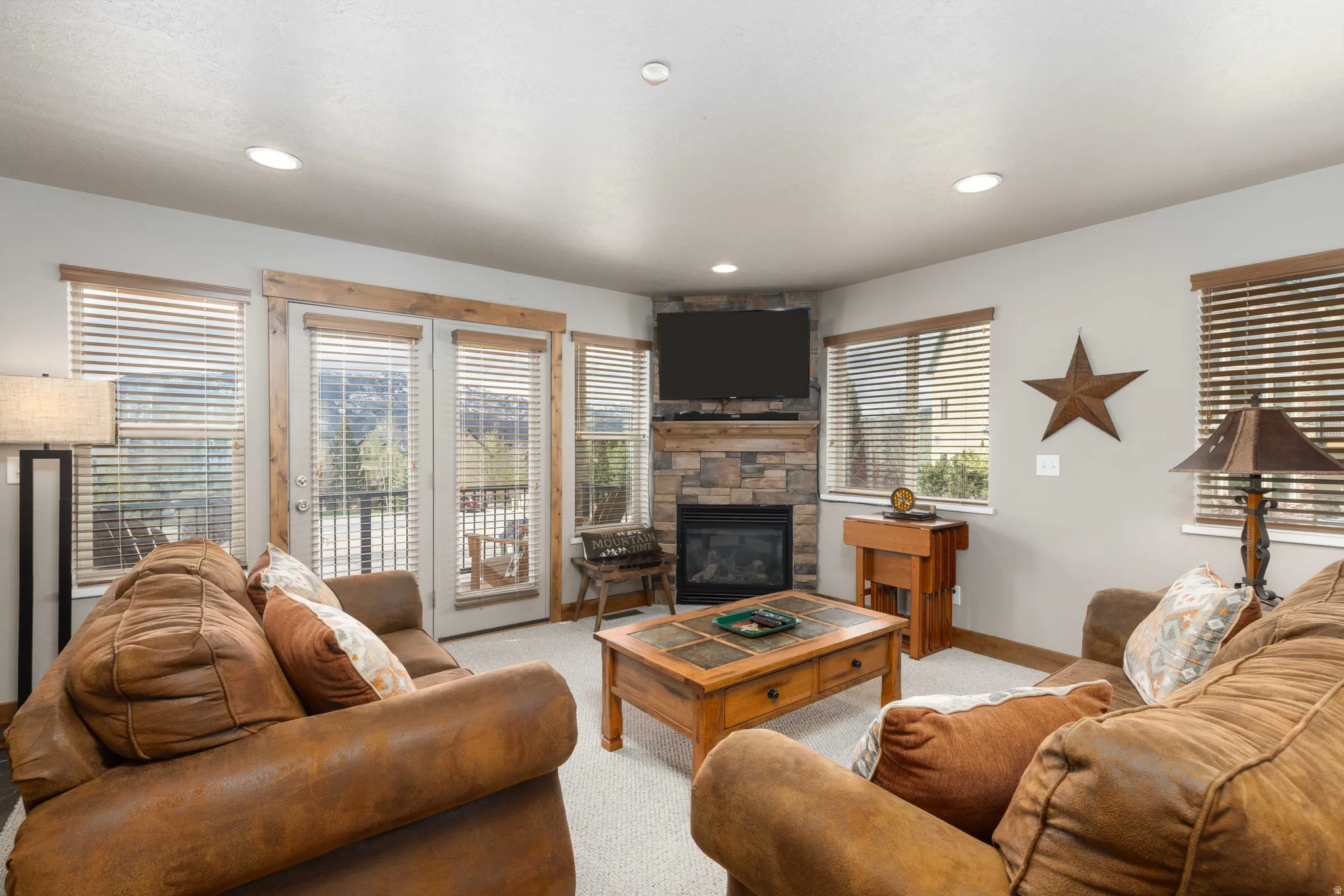 Carpeted living area featuring a fireplace and recessed lighting