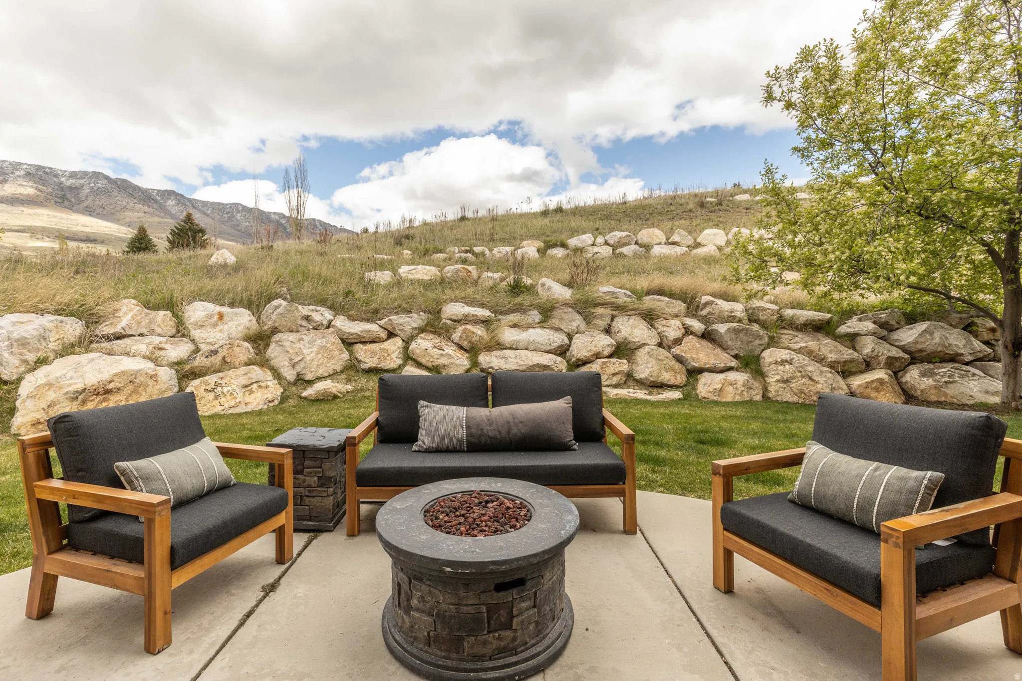 View of patio featuring an outdoor living space with a fire pit and a mountain view