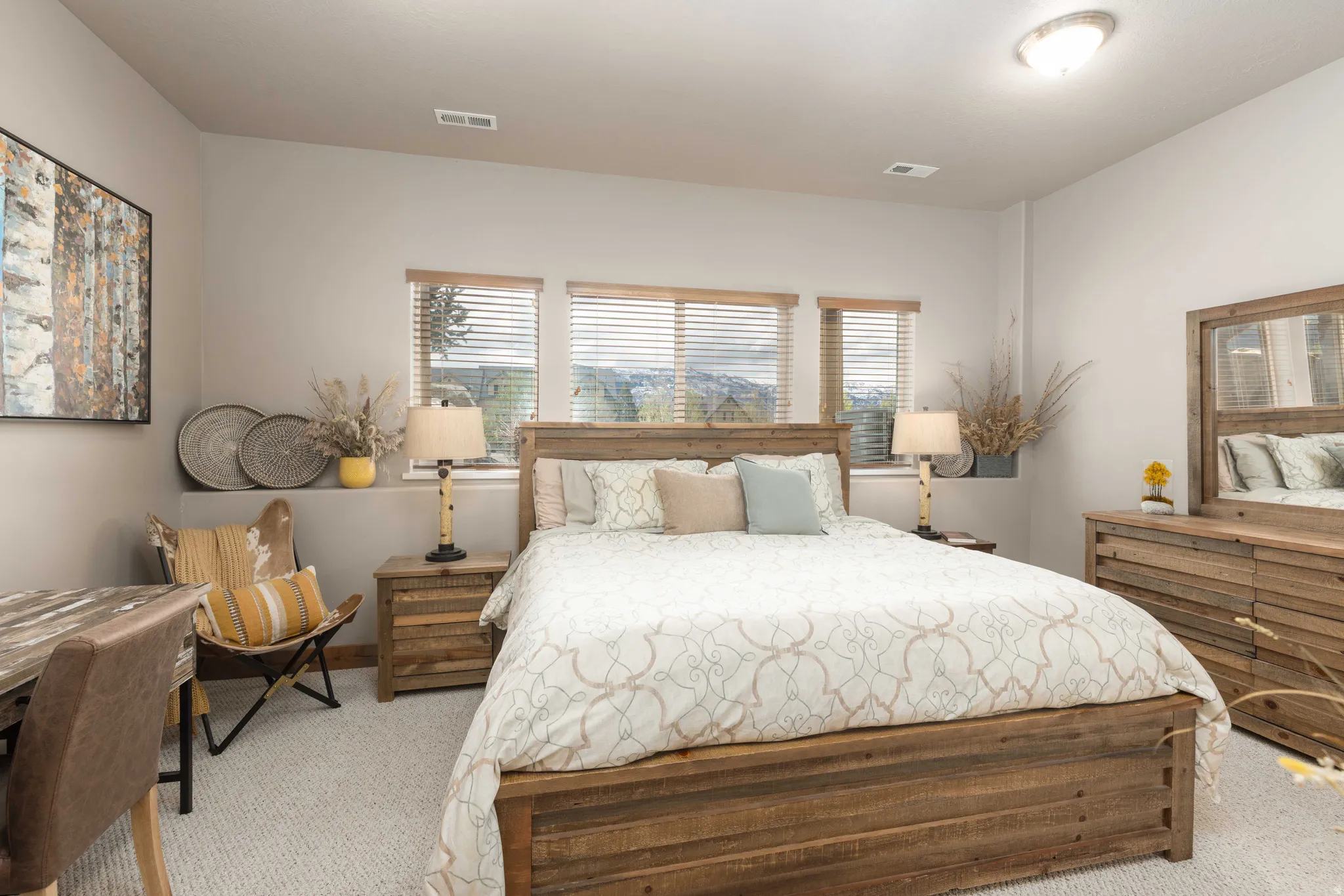 Bedroom with multiple windows and light carpet