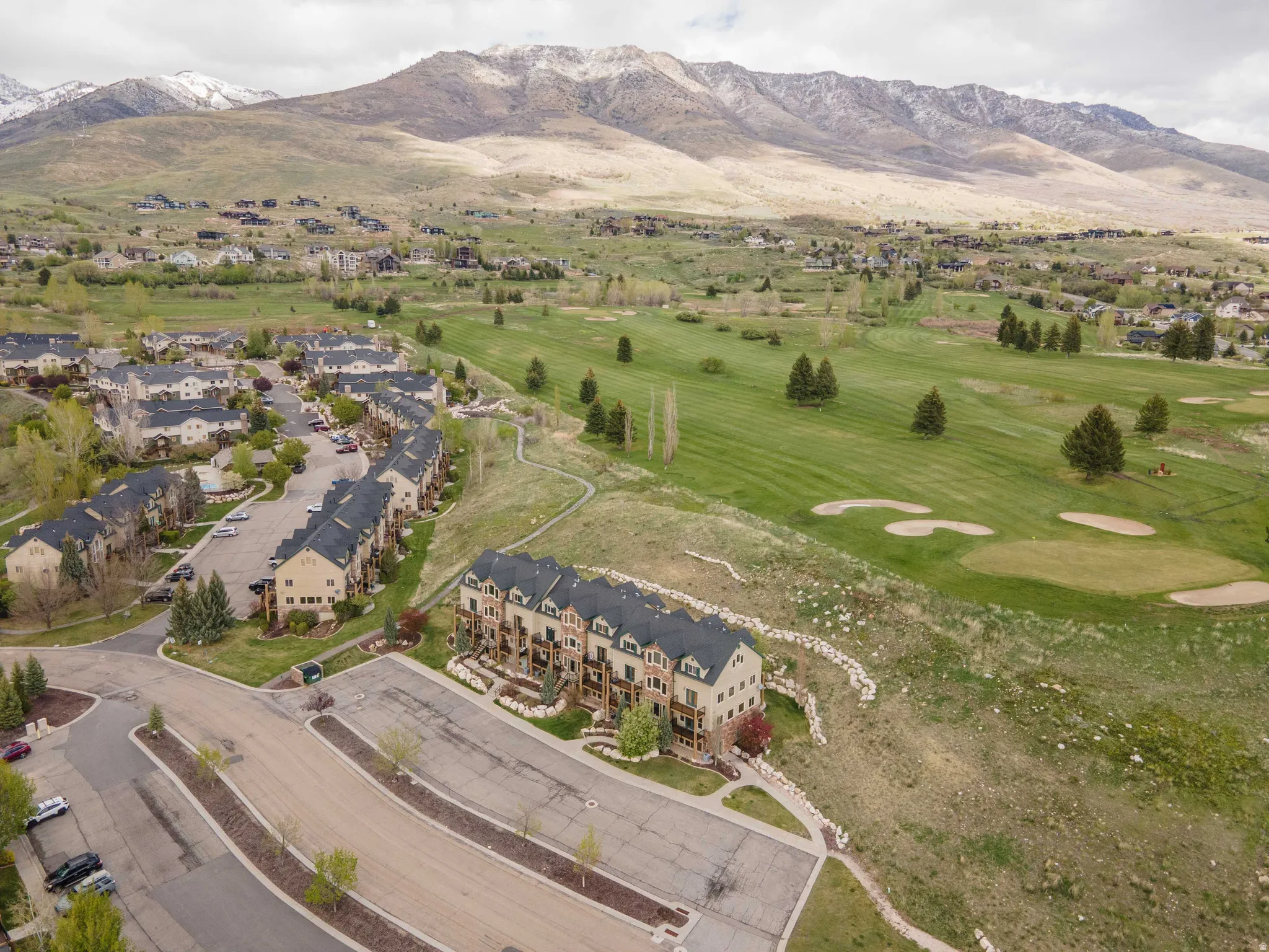 Bird's eye view of a mountainous background and a golf course