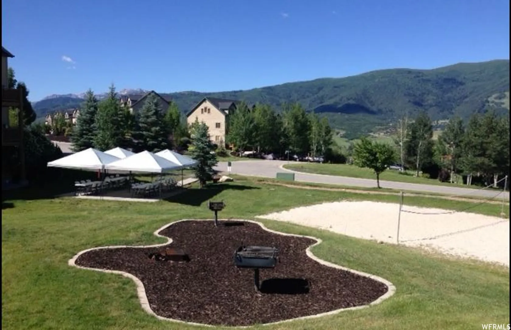 View of community with a mountain view and volleyball court