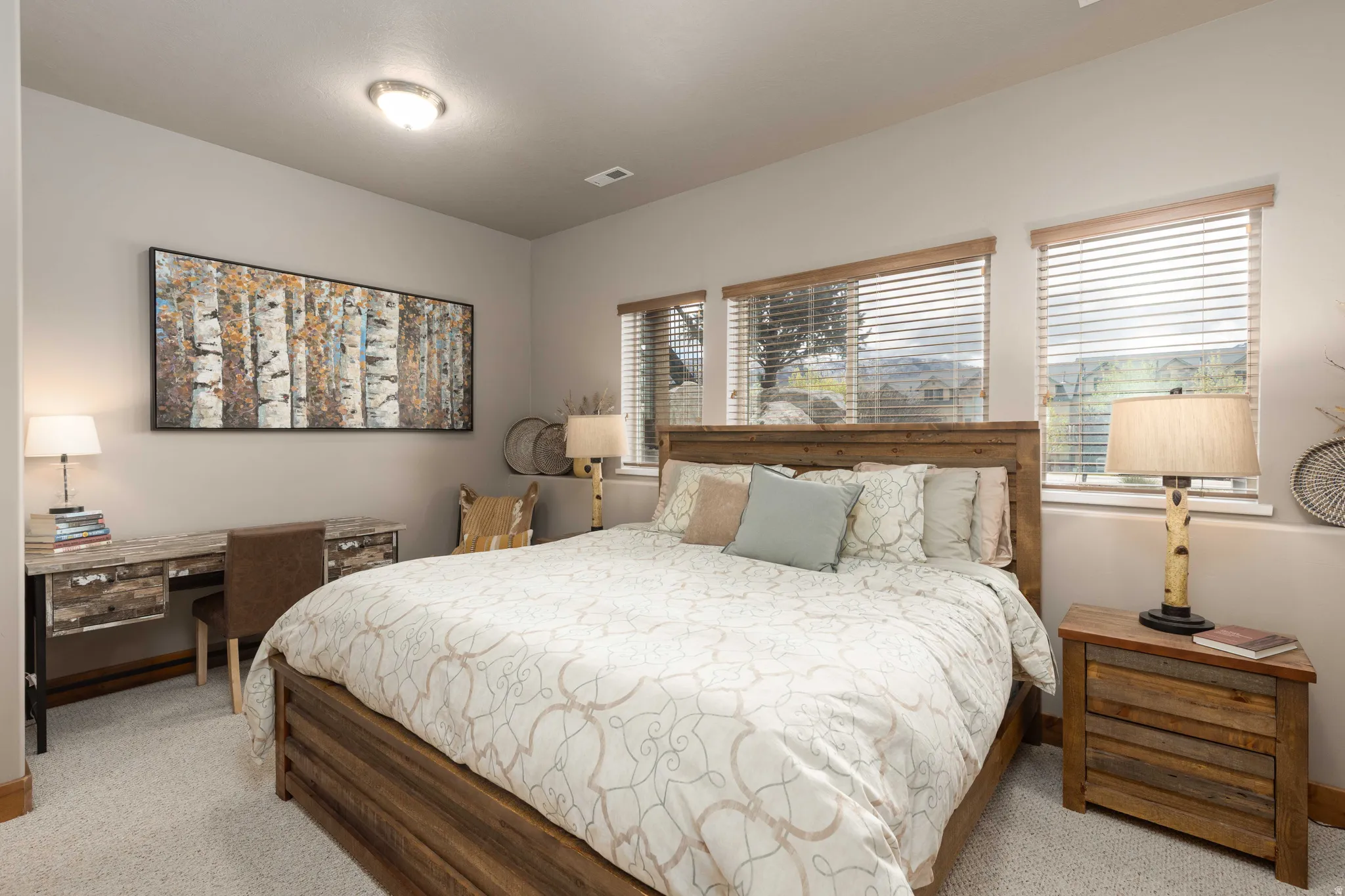 Bedroom featuring a desk and light colored carpet
