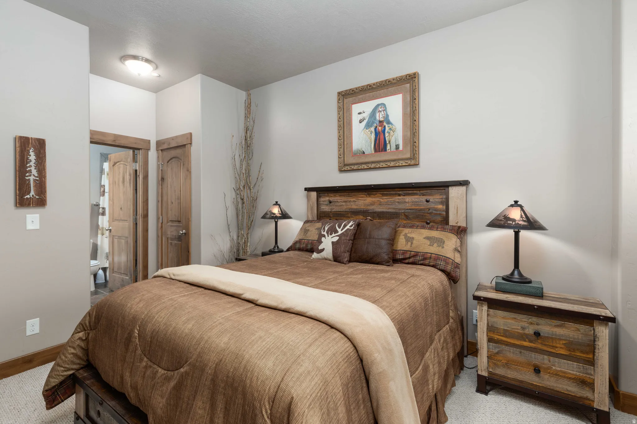 Bedroom featuring a closet, light carpet, and connected bathroom