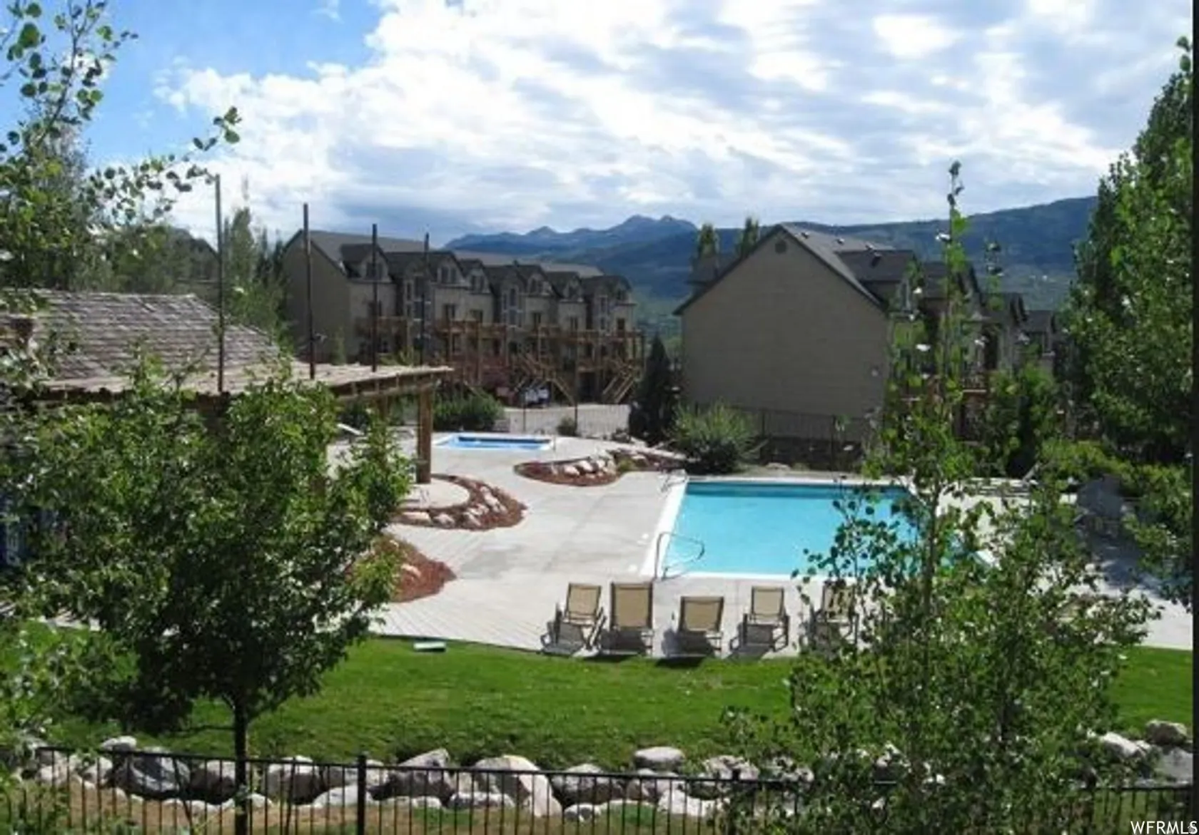 Community pool featuring a patio and a mountain view