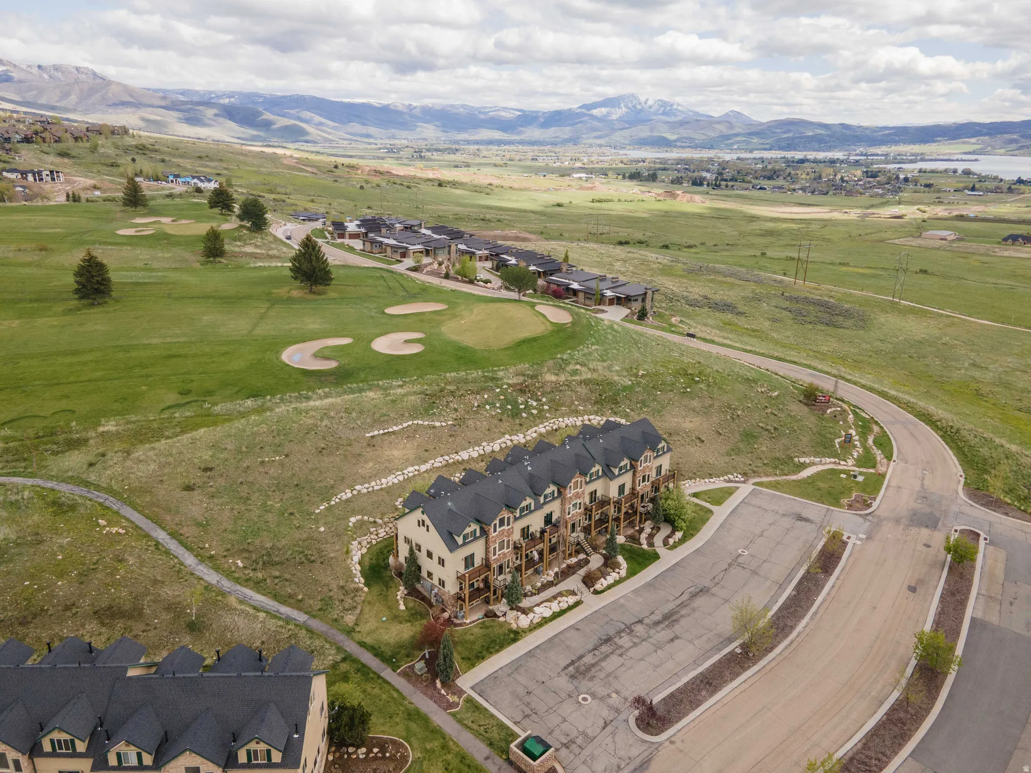 Drone / aerial view of a mountainous background and a golf course