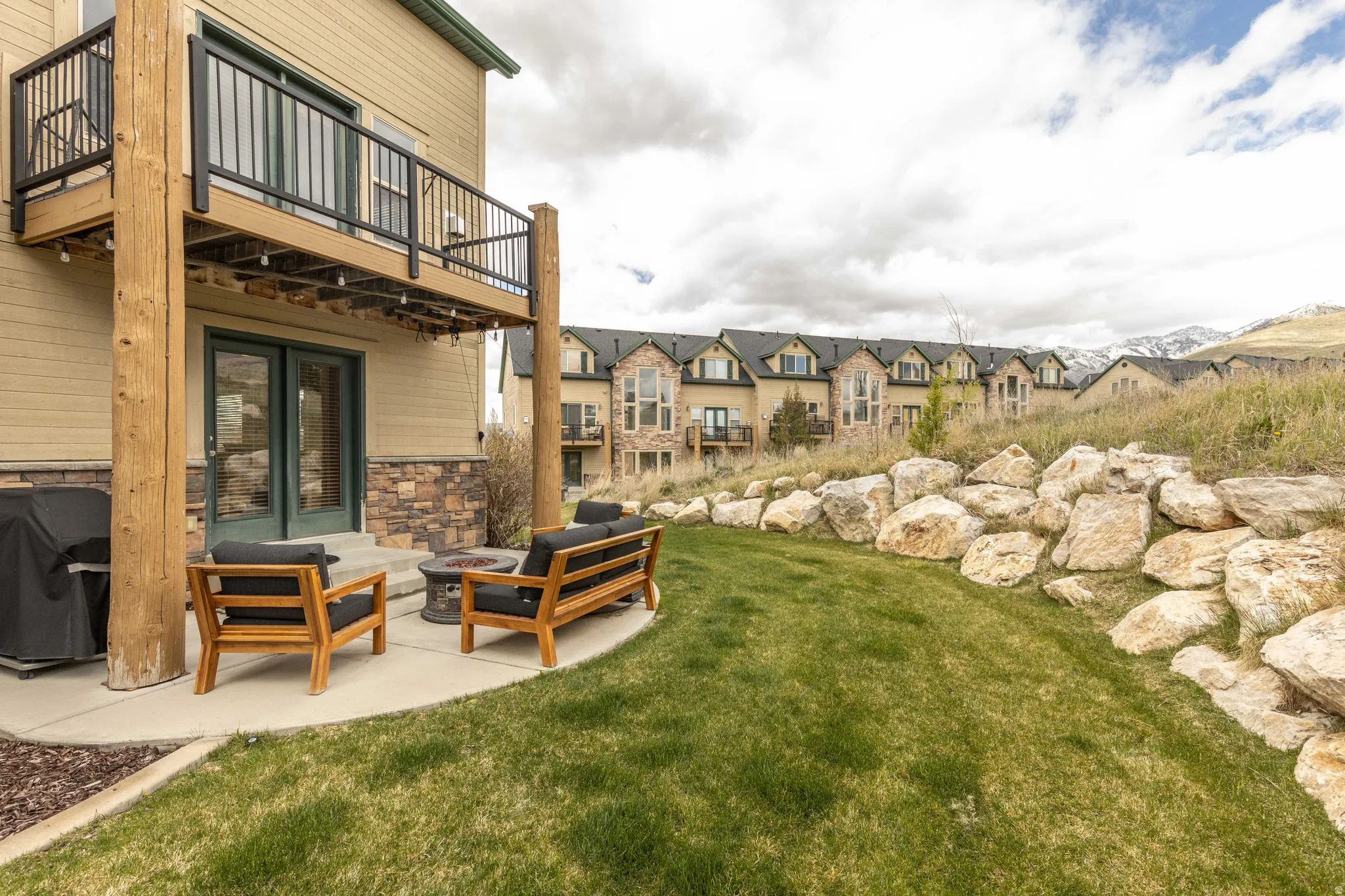 View of green lawn with a patio, a residential view, outdoor lounge area, french doors, and a balcony