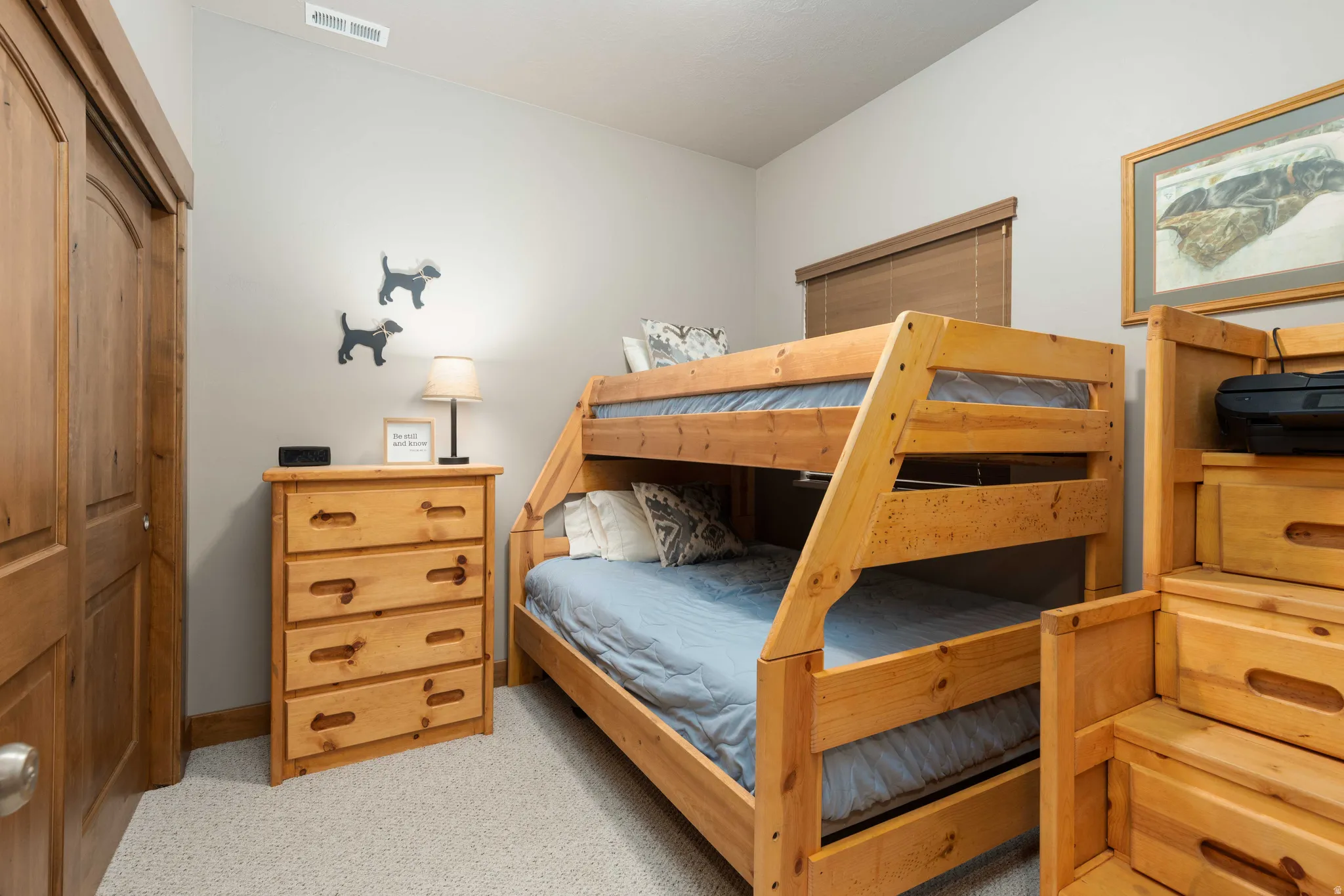 Bedroom featuring light colored carpet and a closet